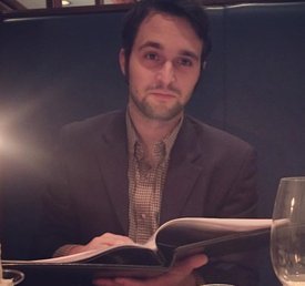 Kellan Head holds an open book