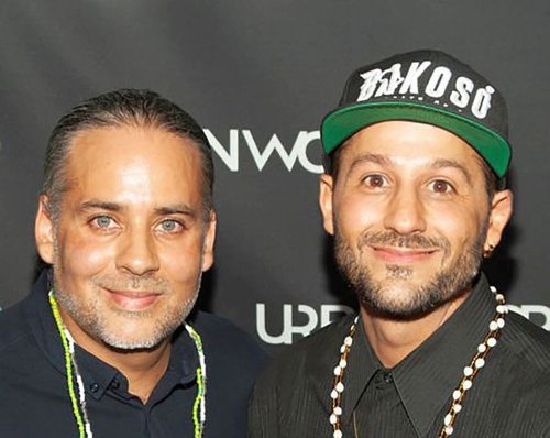 filmmakers Eli and Kahlil Fantauzzi pose in front of black banner