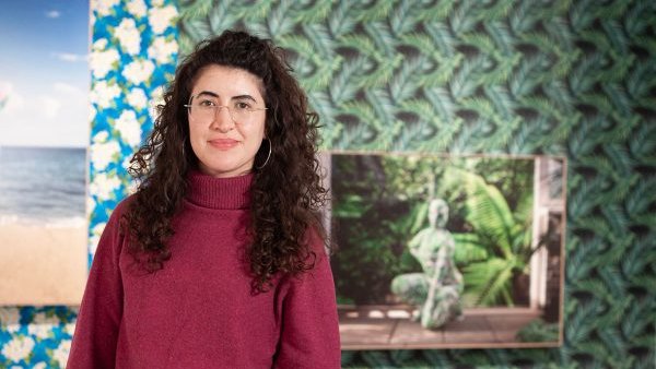 Cristina Pardo Porto stands in front of her curated exhibition, "Joiri Minaya: Unseeing the Tropics"