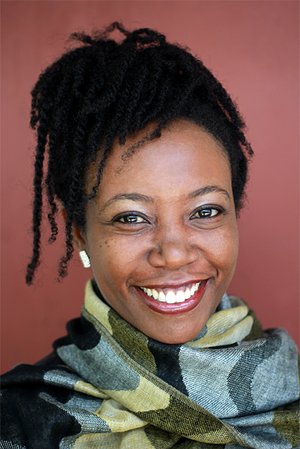 Marsha Pearce smiling, wearing scarf