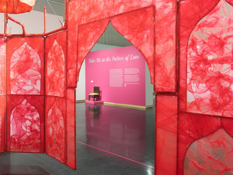 red and pink entryway to Rina Banerjee's art exhibit, Take Me to the Palace of Love