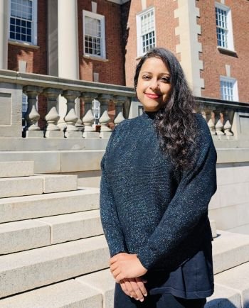 Sayantika Chakraborty stands in front of Maxwell Hall stairs