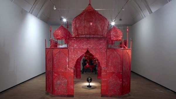 Rina Banerjee's large art installation, a reddish pink construct called "Take Me to the Palace of Love"