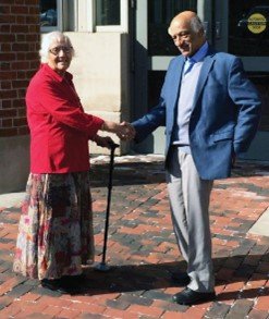 Kashi and Kamesh Wali join hands in front of a bricked walkway