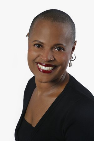 headshot of author  Sapphire wearing black top against white background